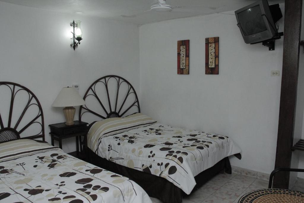 Postel nebo postele na pokoji v ubytování Hotel Posada del Angel