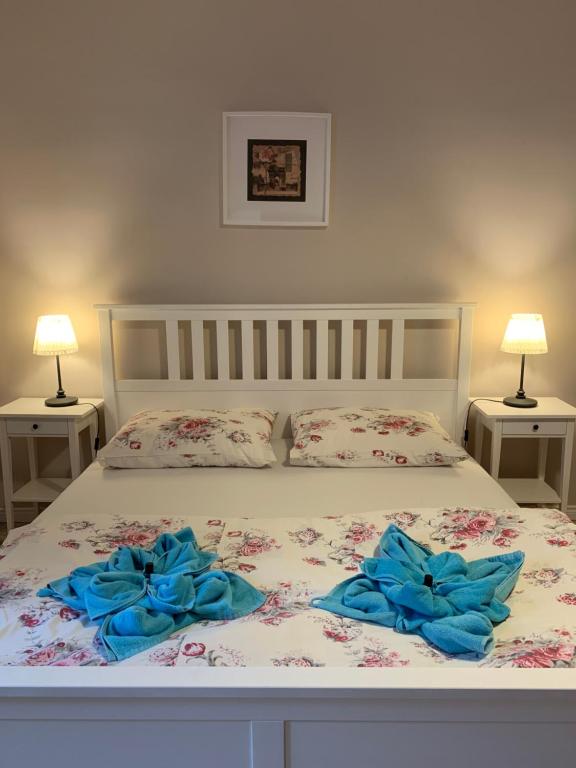 a bed with two blue bows on top of it at Apartament Romantic in Oświęcim