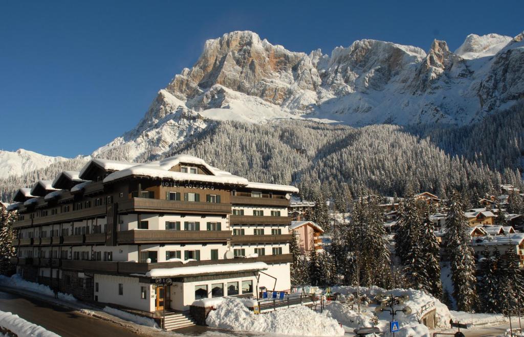 a large building with a ski lift on top of it at Hotel Colfosco in San Martino di Castrozza