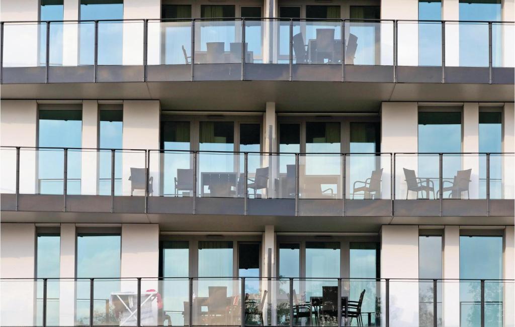 an external view of a building with chairs and tables at Highend Travemünde - Whg 303 in Travemünde