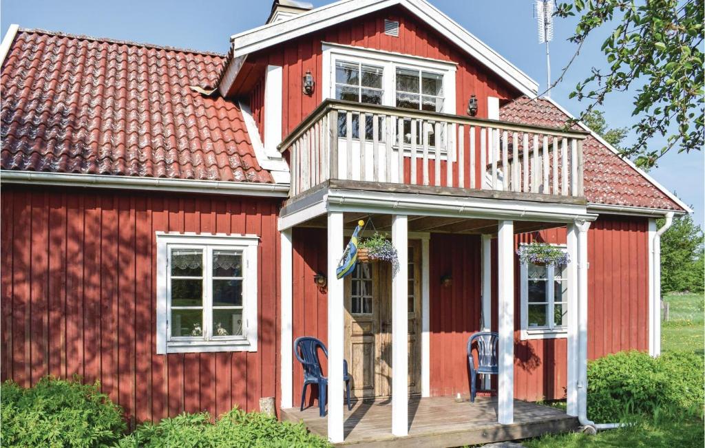 a red house with a porch and a deck at Lovely Home In Virserum With Wifi in Virserum