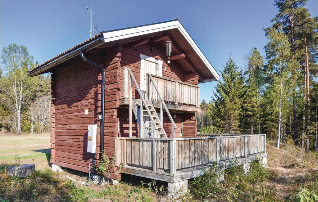 a log cabin with a porch and a deck at Beautiful Home In Ambjörby With Sauna in Ambjörby
