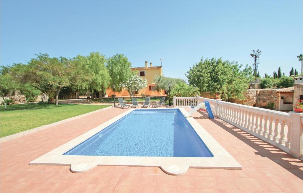 a swimming pool on a patio next to a house at Awesome Home In Sencelles With Outdoor Swimming Pool in Sencelles