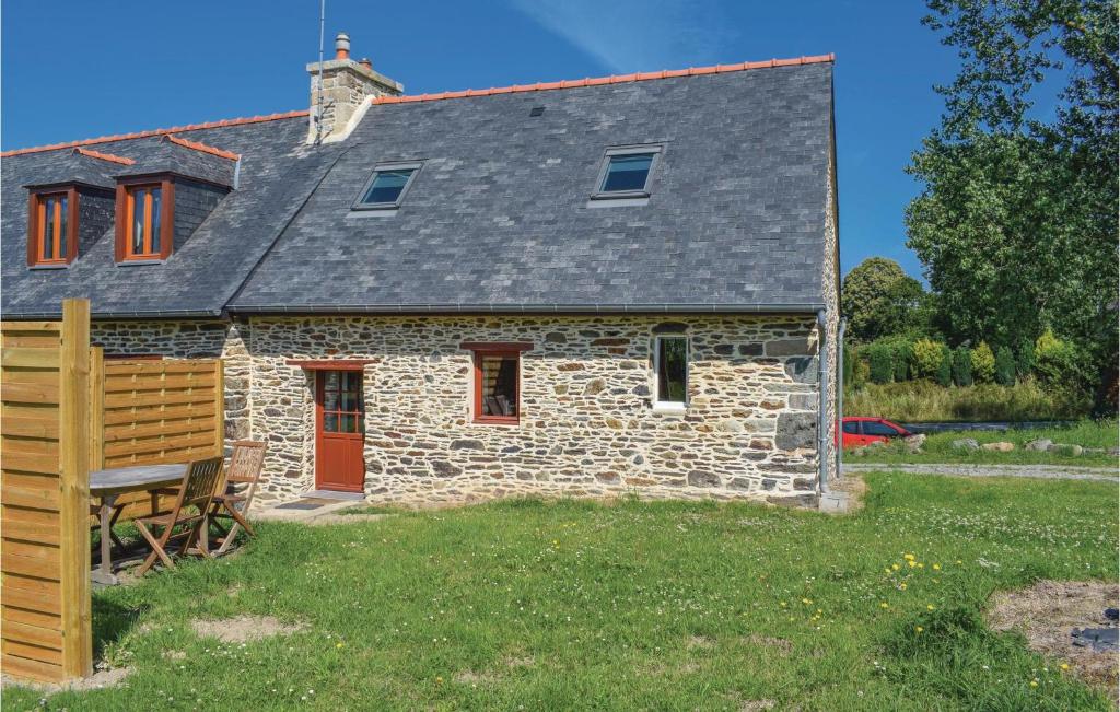 an old stone house with a red door at Amazing Home In Minihy Treguier With 1 Bedrooms And Wifi in Minihy-Tréguier