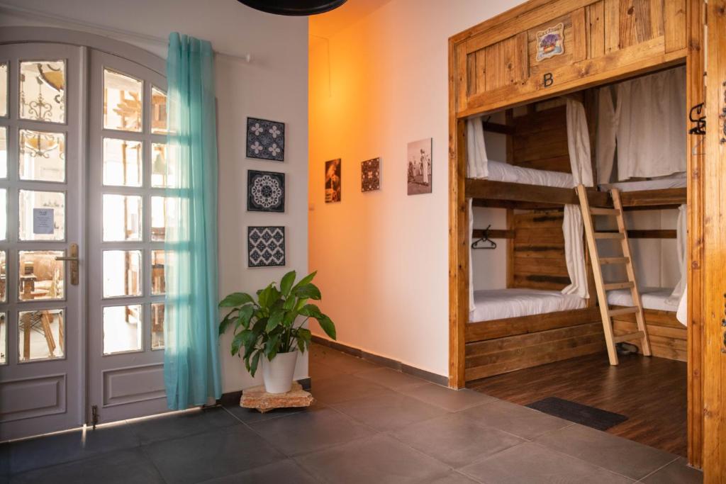 a room with bunk beds and a door at The Cabin in Amman