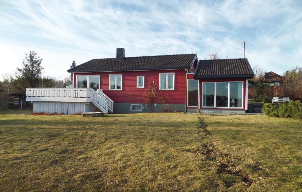 a red house with a large yard in front of it at Nice Studio In Gravdal With Kitchen in Gravdal