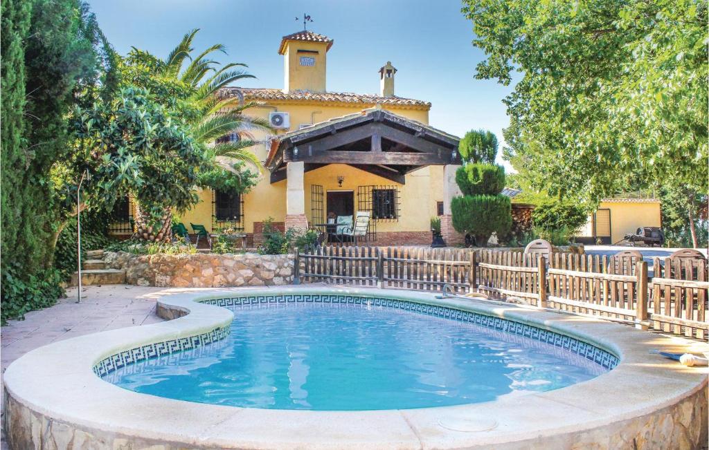 a swimming pool in front of a house at 4 Bedroom Amazing Home In Albacete in Fuente-Álamo