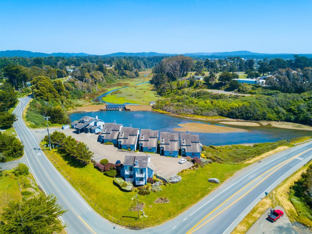 an aerial view of a river with houses and a road at Beach House Inn in Fort Bragg