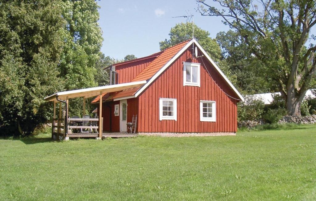 a red barn sitting in a field of grass at Amazing Home In Ljungby With Wifi in Bolmstad
