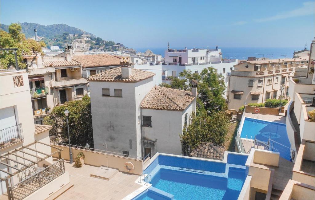 a view from the balcony of a building with a swimming pool at Beautiful Home In Tossa De Mar With 4 Bedrooms, Wifi And Swimming Pool in Tossa de Mar