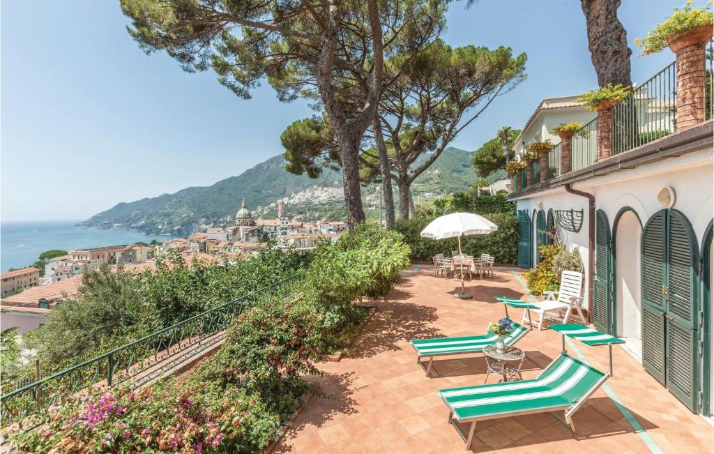 a patio with chairs and tables and a view of the ocean at Casa Sorvillo in Vietri sul Mare