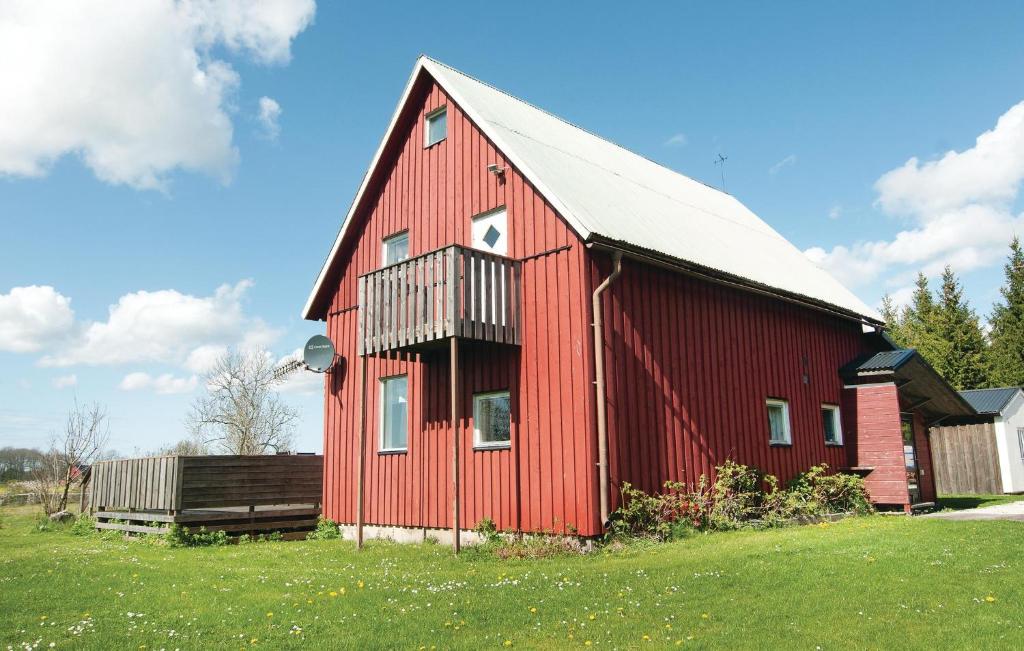 a red barn with a white roof in a field at Nice Home In Romakloster With 3 Bedrooms And Wifi in Romakloster