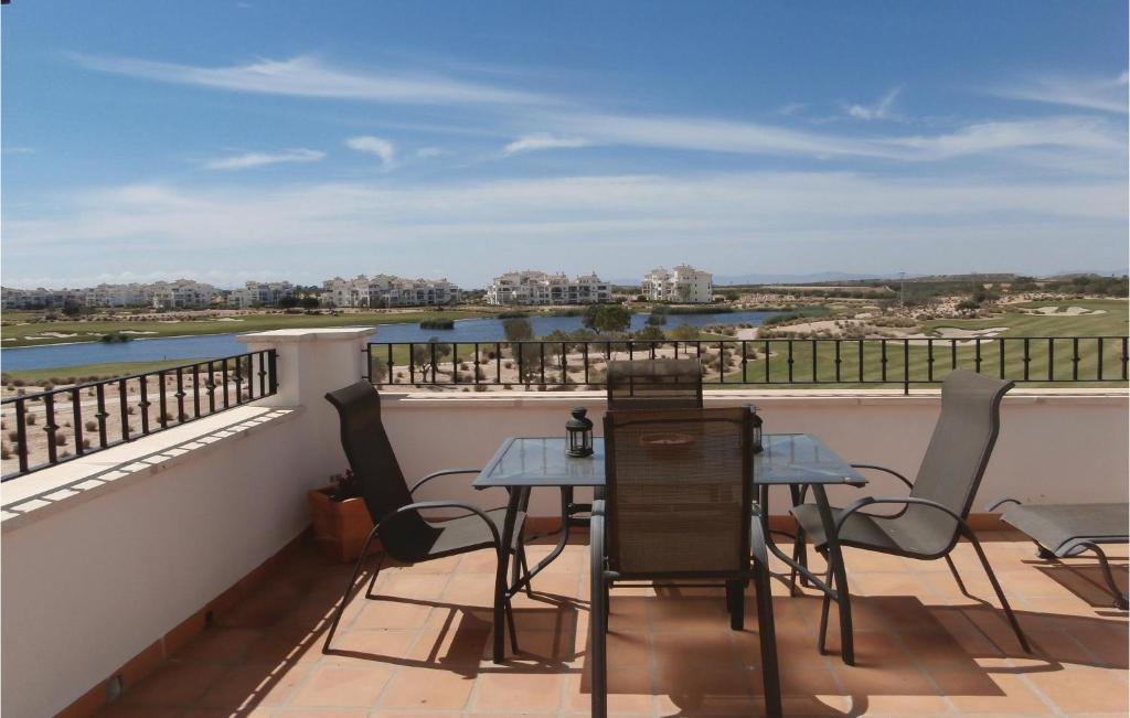 a patio with a table and chairs on a balcony at Hacienda Riquelme in Sucina