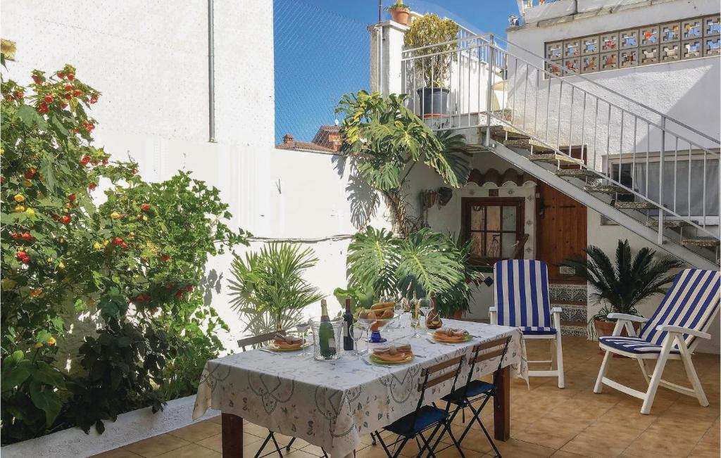 a table and chairs on a patio with plants at 3 Bedroom Beautiful Apartment In Pineda De Mar in Pineda de Mar