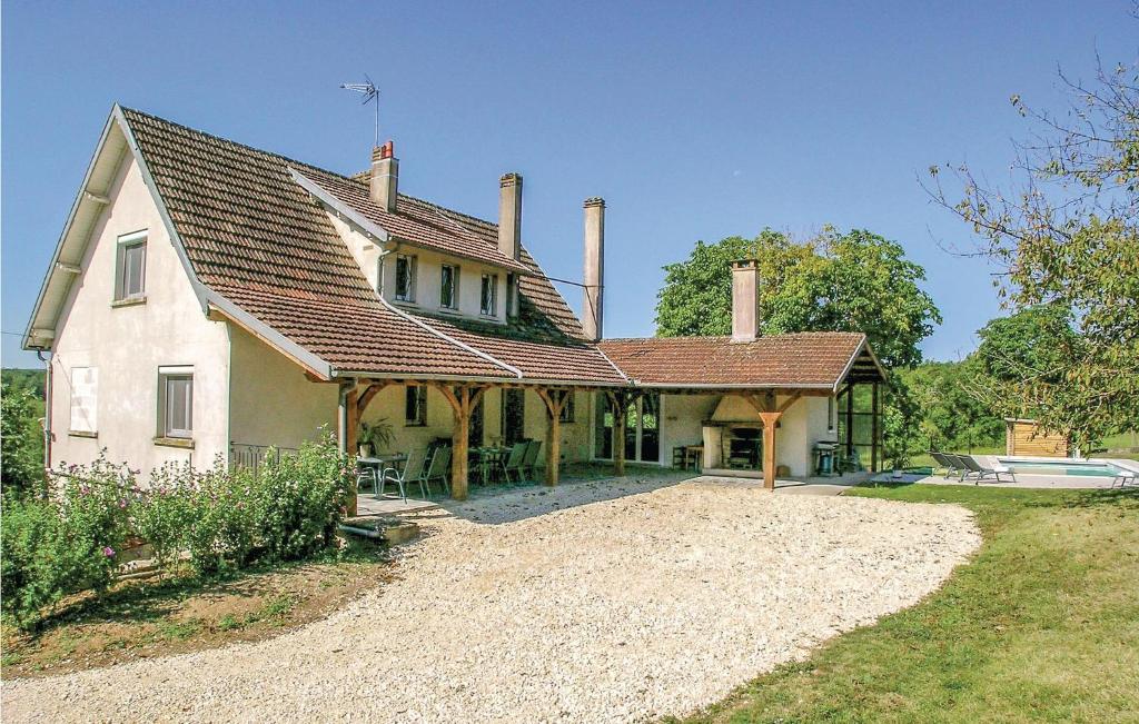 a large white house with a roof and a yard at Beautiful Home In Eyliac in Saint-Laurent-sur-Manoire