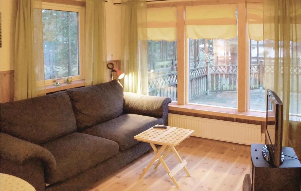 a living room with a couch and a table at 1 Bedroom Amazing Home In Yngsj in Yngsjö