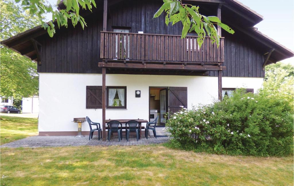 a house with a balcony and a table at Ferienhaus 17 In Thalfang in Thalfang