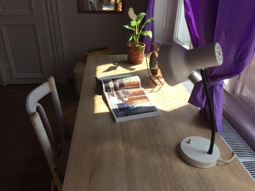 a table with a lamp and a vase on it at Zen Hostel by Central Market in Budapest