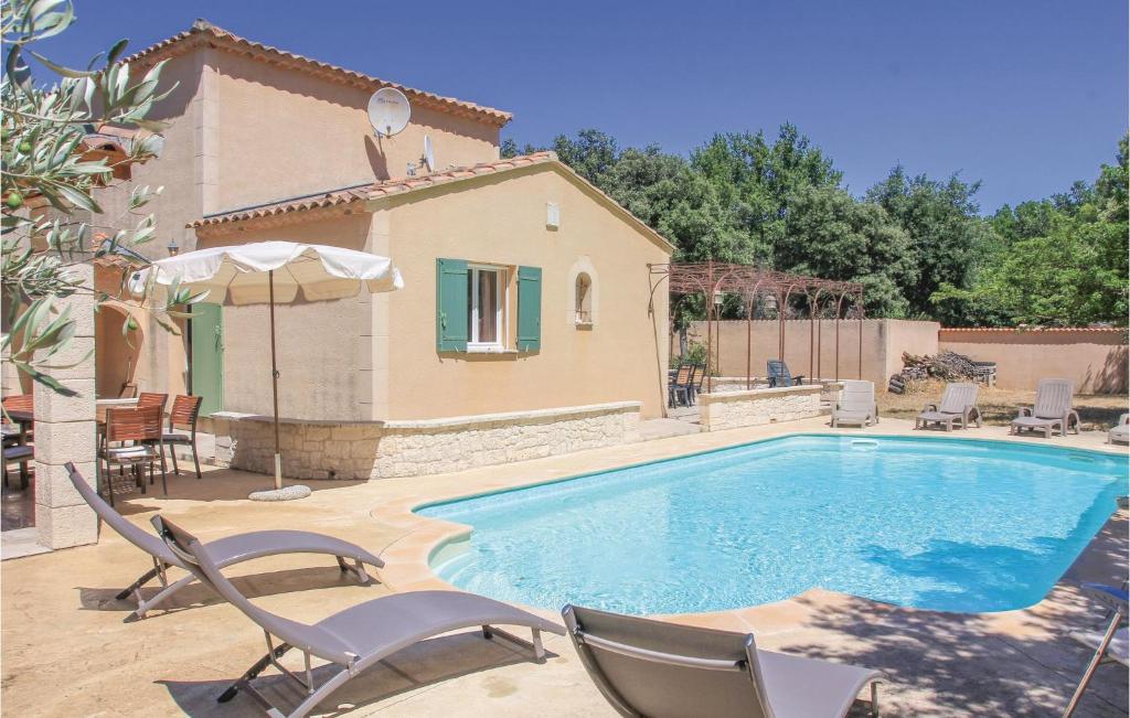 a swimming pool with chairs and a house at Stunning Home In Saint Didier With Private Swimming Pool, Can Be Inside Or Outside in Saint-Didier
