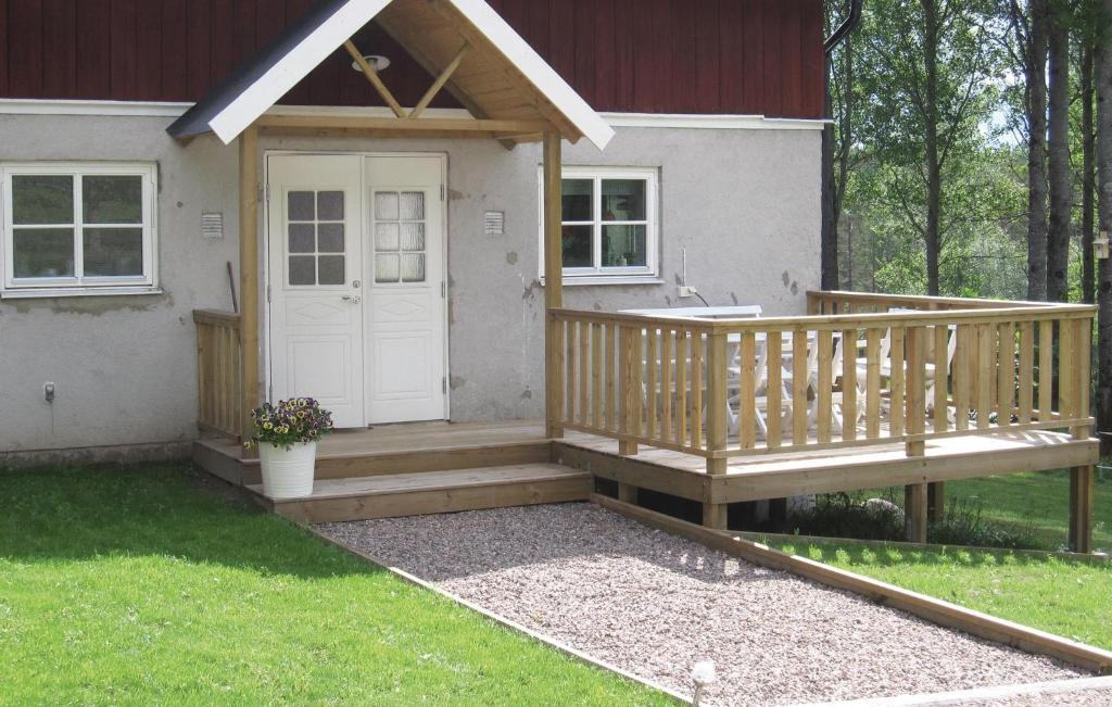 a porch with a white door on a house at Awesome Home In Hestra With 2 Bedrooms And Wifi in Valdshult