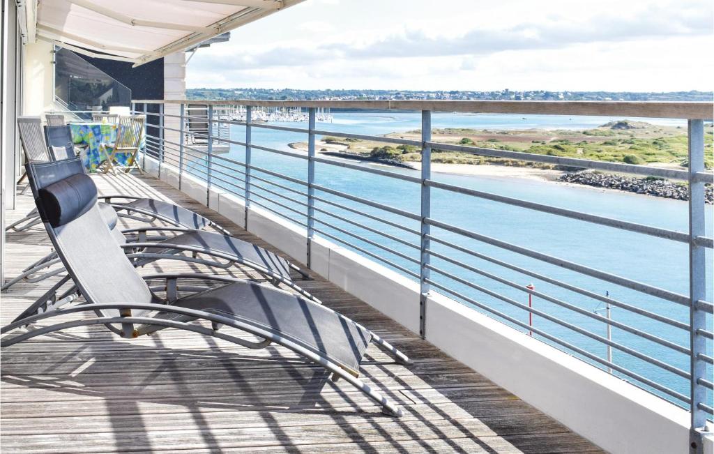 a balcony with a bench and a view of the water at Nice Apartment In Barneville-carteret With 4 Bedrooms And Wifi in Barneville-Carteret