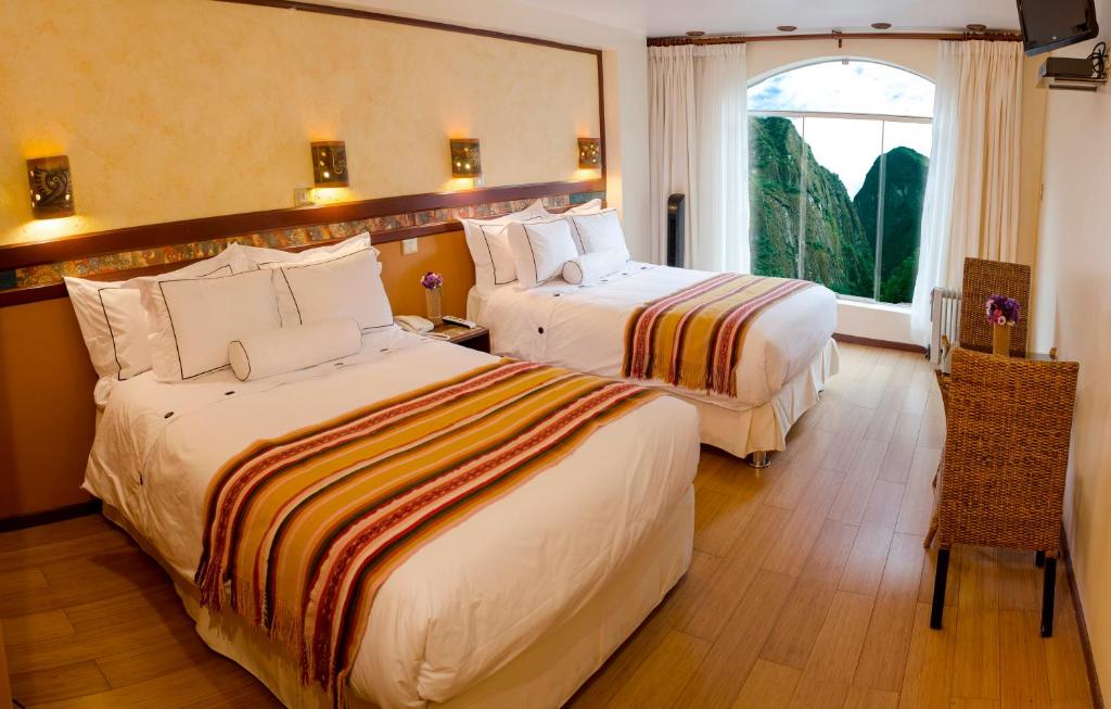 Postel nebo postele na pokoji v ubytování Hotel Taypikala Machupicchu