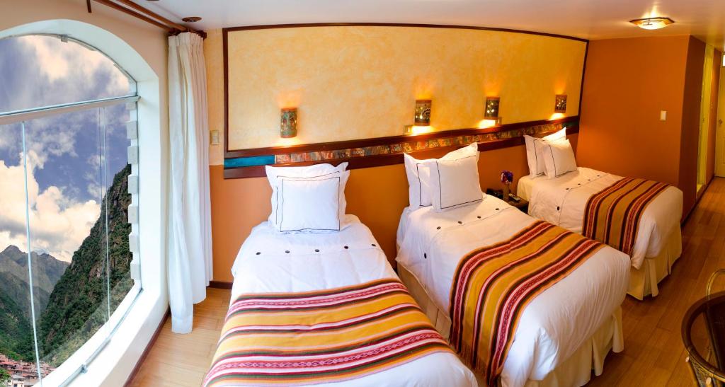 Postel nebo postele na pokoji v ubytování Hotel Taypikala Machupicchu