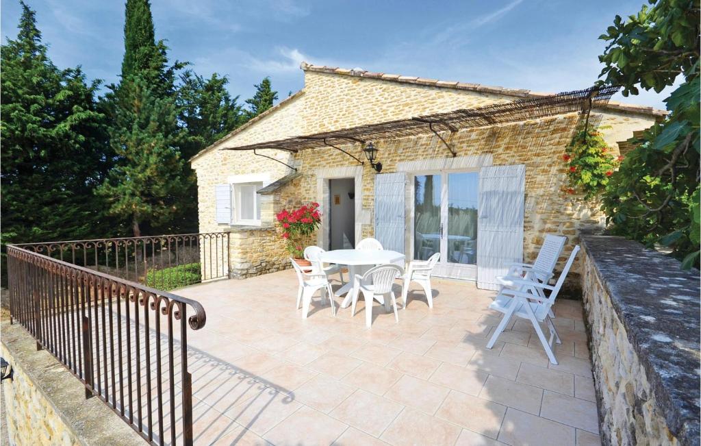 a patio with a white table and chairs at Lovely Home In Montbrison Sur Lez in Peyrol