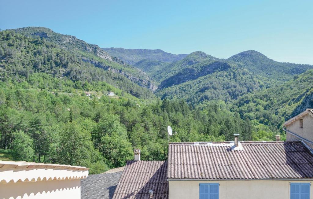 a view of the mountains from the roofs of houses at Beautiful Home In Cuebris With 1 Bedrooms in Cuébris