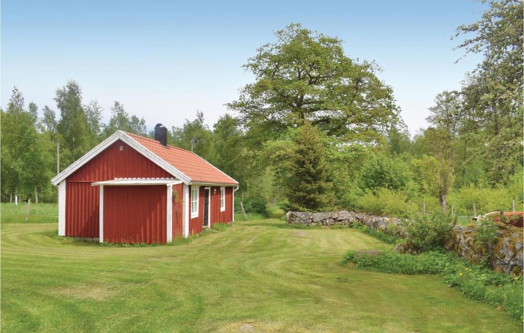 a red barn in the middle of a yard at Awesome Home In Ryd With Kitchen in Ryd