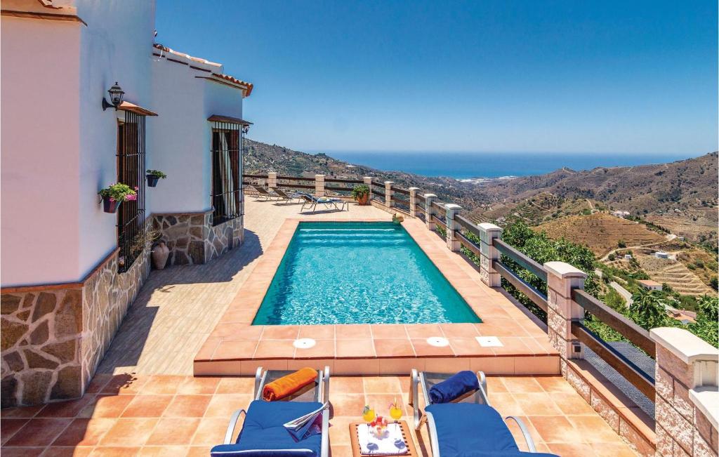 a swimming pool on a balcony with a view of the ocean at Beautiful Home In Cómpeta in Sayalonga