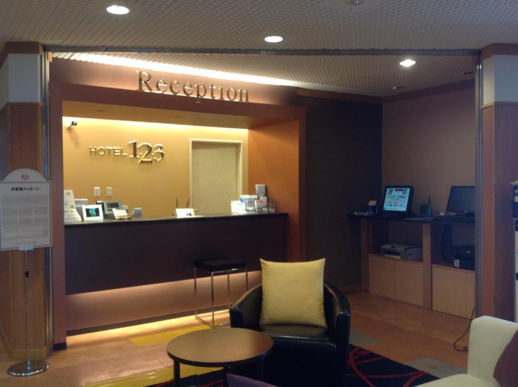 a waiting room with a reception counter and a chair at Hotel 1-2-3 Shimada in Shimada