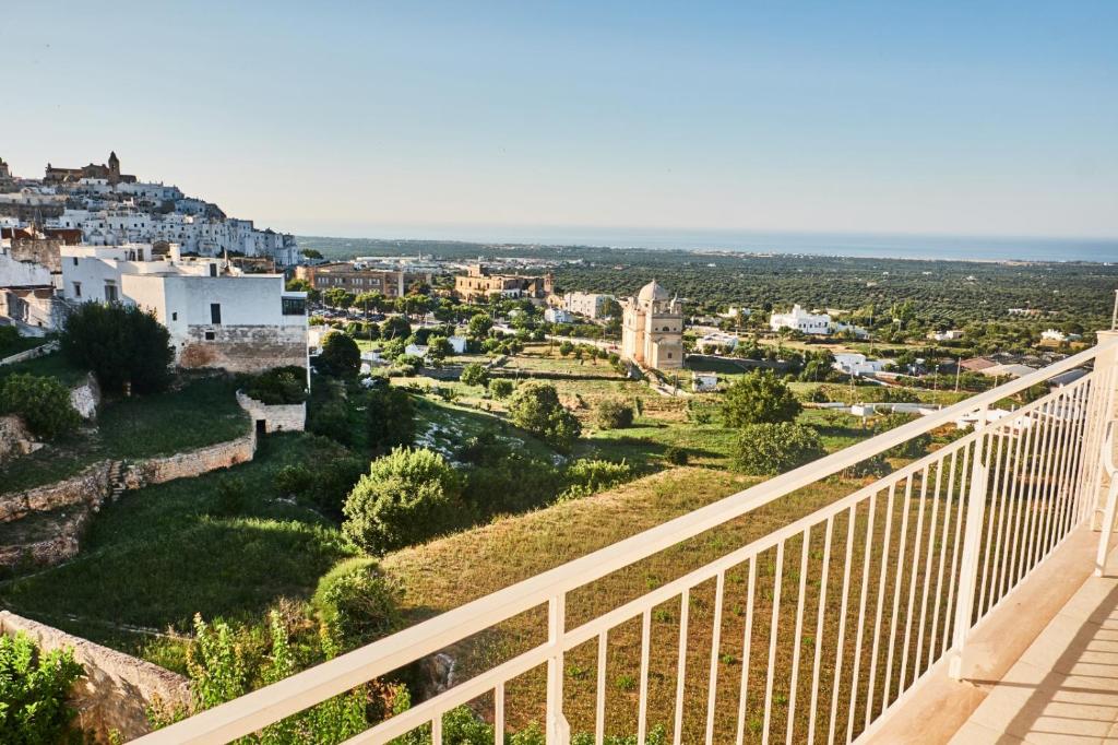 a view of the city from the balcony of a building at EQUORUM Delicious Suite - Ostuni Centro in Ostuni