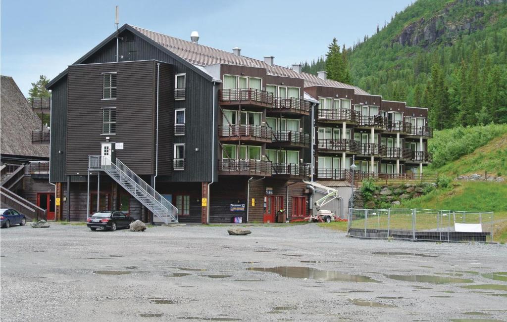 a large building with a parking lot in front of it at Nice Apartment In Hemsedal With Wifi in Hemsedal