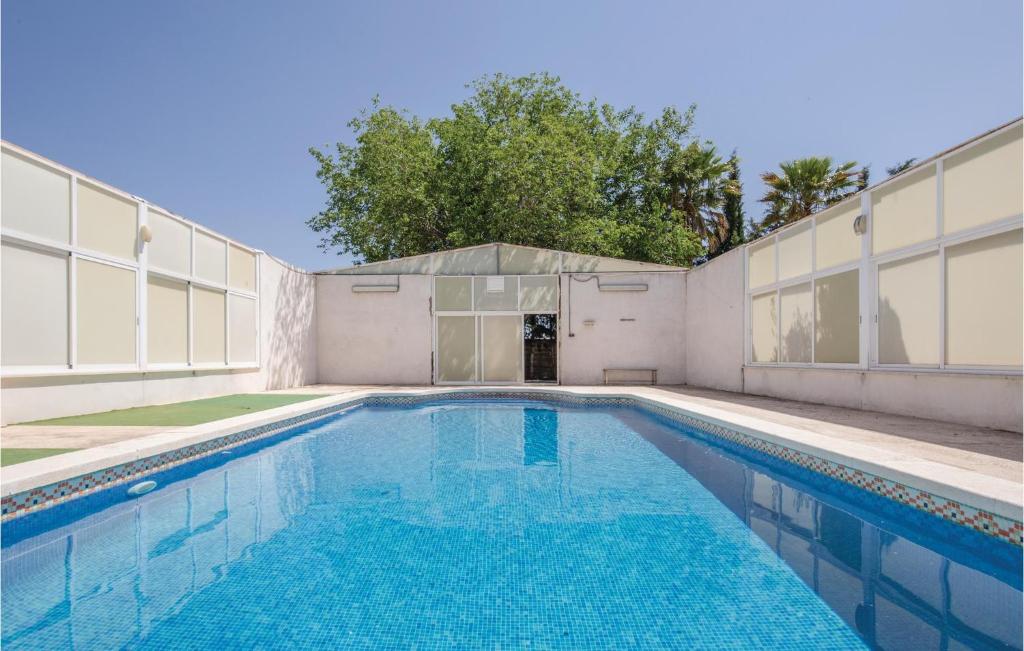 a swimming pool in front of a building at Awesome Home In Caravaca With Kitchen in Caravaca de la Cruz