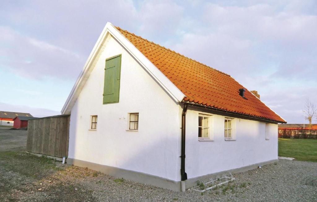 a small white house with an orange roof at Stunning Home In Tomelilla With Wifi in Bollerup