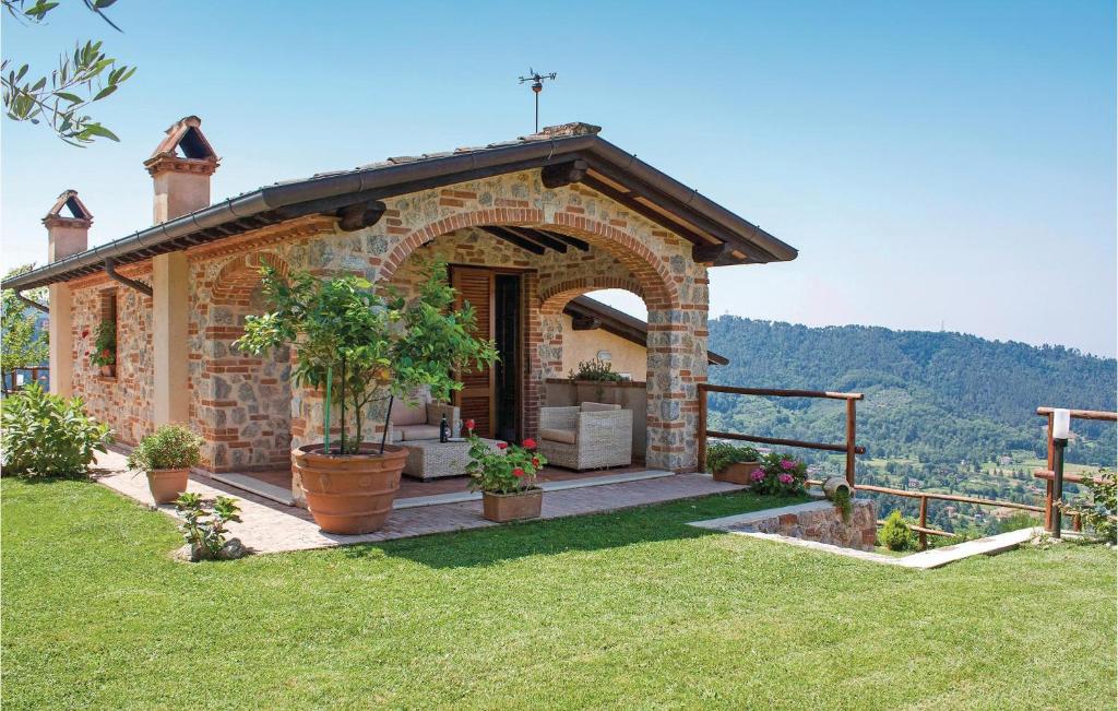 a small stone house with a patio with a view at La Rosa E Il Limone in Montemagno