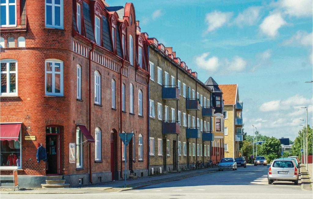a row of brick buildings on a city street at Awesome Apartment In Ystad With Kitchen in Ystad