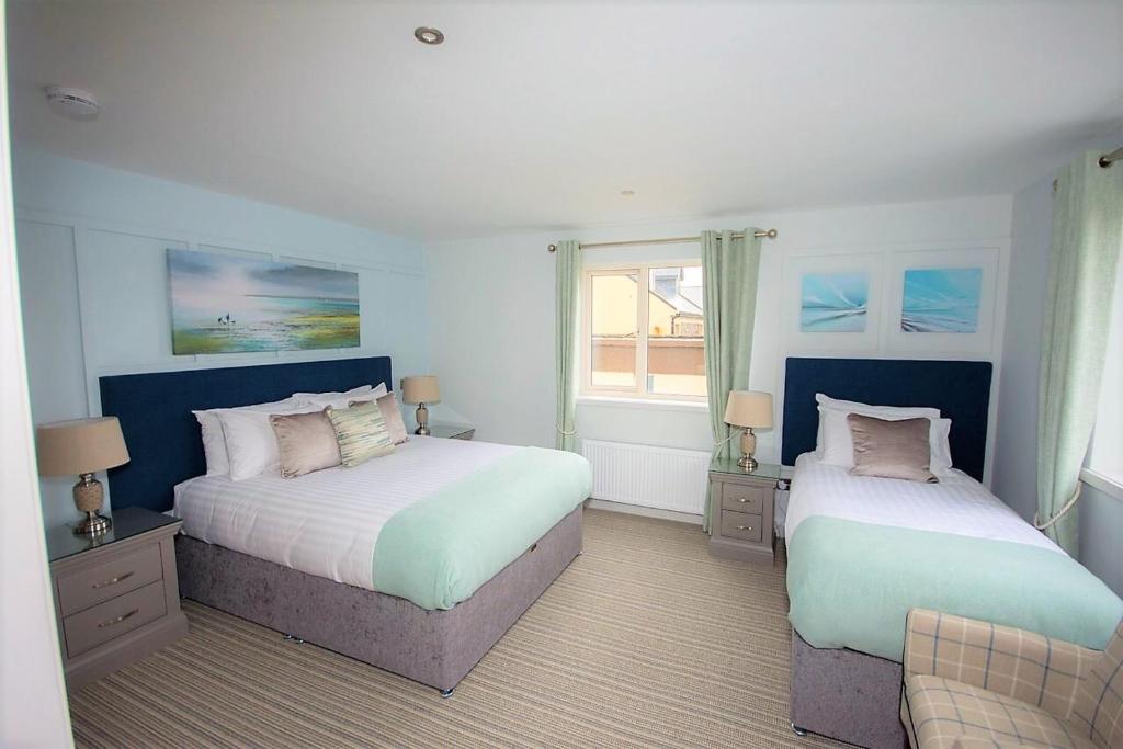 a bedroom with two beds and a window at Seaclusion Luxury Guest Accommodation in Waterville