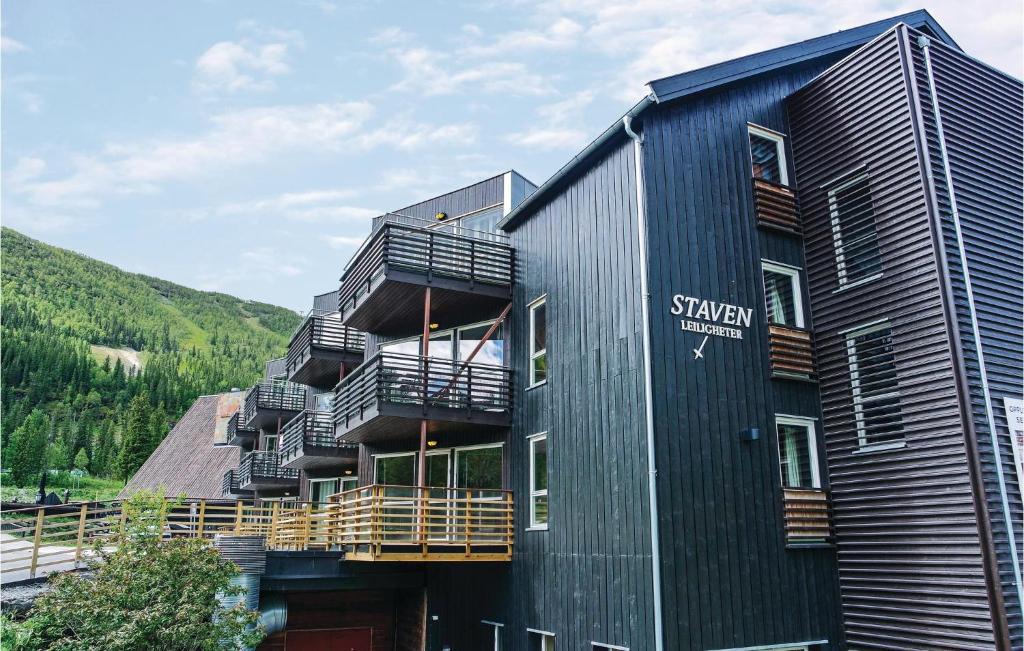 a black building with balconies on the side of it at Beautiful Apartment In Hemsedal With House A Mountain View in Hemsedal