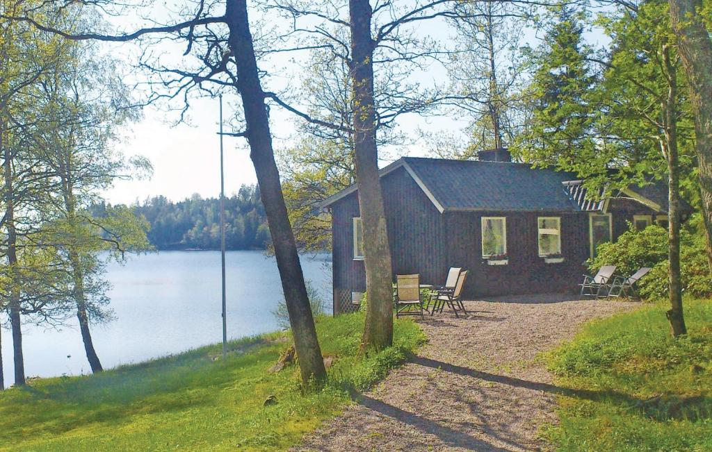 a cabin on the shore of a body of water at Beautiful home in Frgelanda with 4 Bedrooms and WiFi in Färgelanda