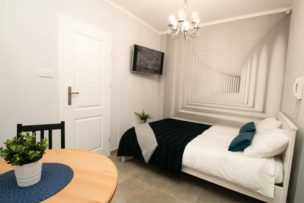 a small bedroom with a bed and a table at GOOD NIGHT | city Police (3km) | Szczecin | 2 pers in Szczecin