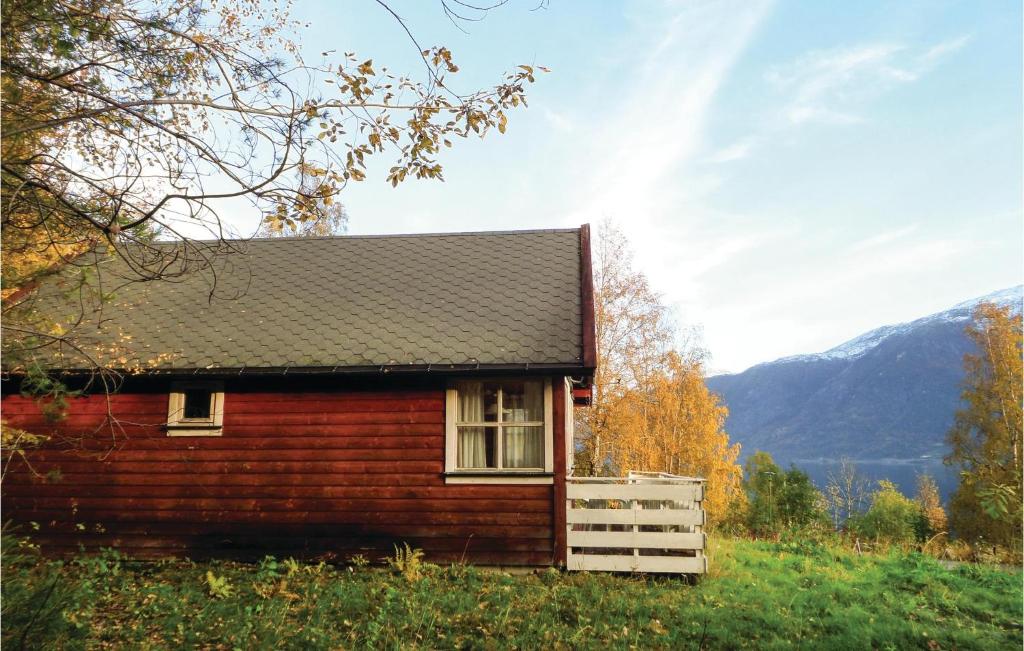 a small wooden cabin in the middle of a field at 3 Bedroom Nice Home In Vallavik in Vangsbygd