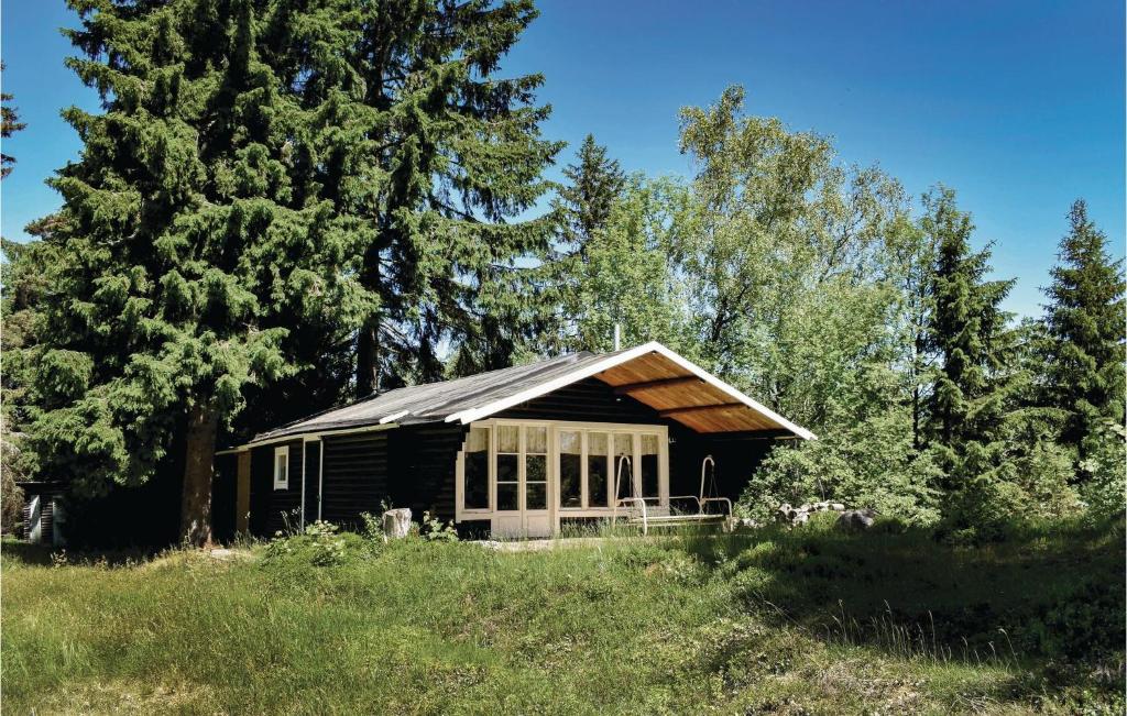 a small cabin in a field with trees at Two-Bedroom Holiday Home In Mansarp in MÃ¥nsarp
