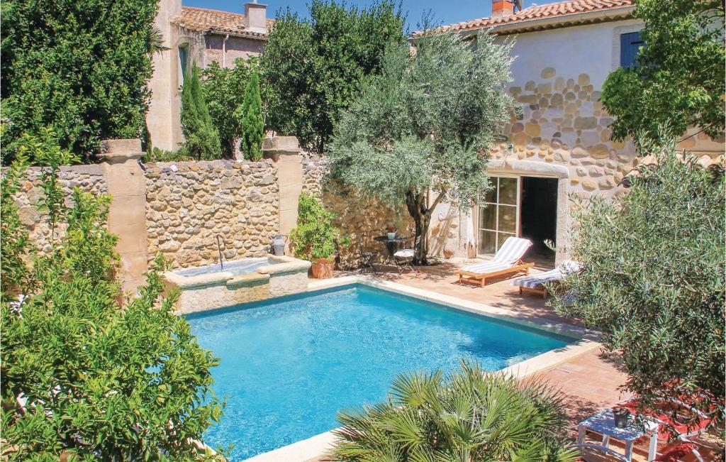 a swimming pool in front of a house at Gorgeous Home In Roujan With Wifi in Roujan