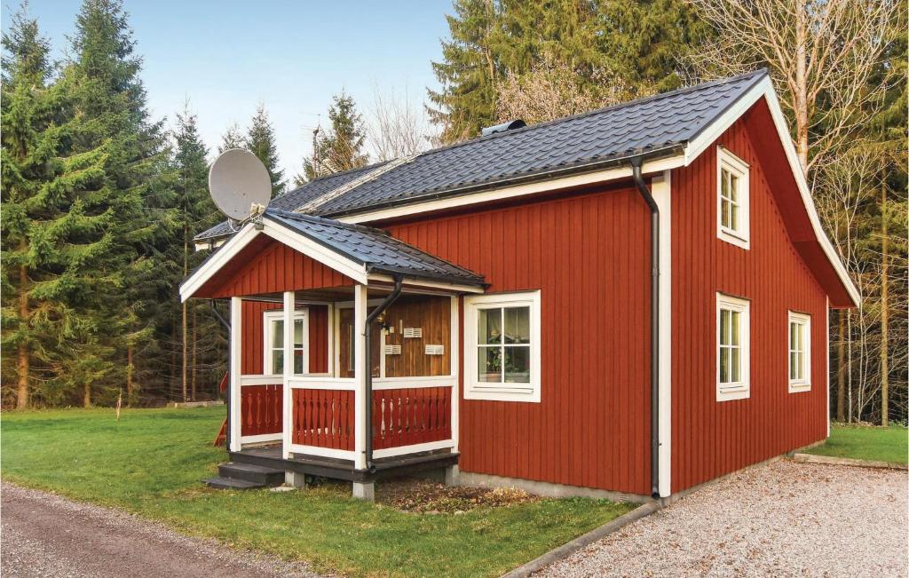 a red tiny house with a satellite at Beautiful Home In Väse With Kitchen in Ve