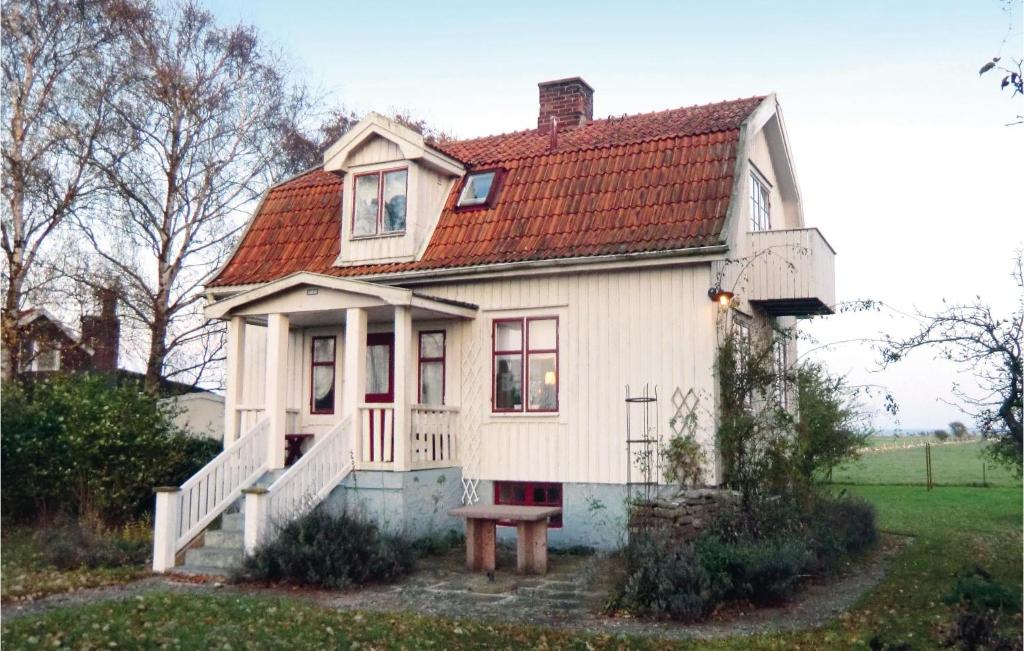 a small white house with a red roof at Stunning Home In Degerhamn With Wifi in Gammalsby