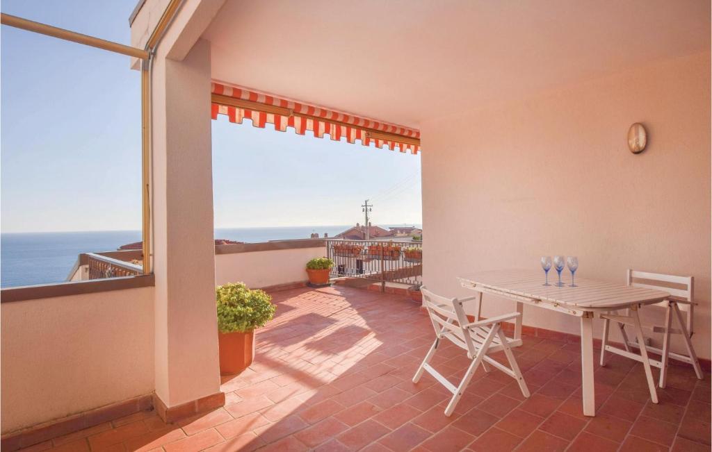 a dining room with a table and a view of the ocean at Casa La Piazzetta in Ospedaletti