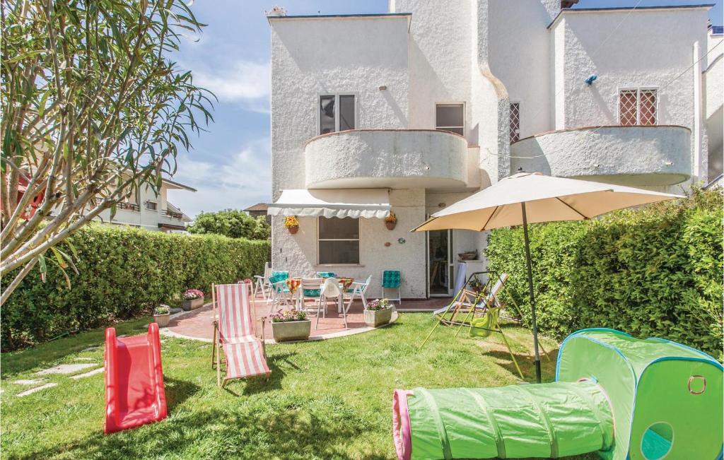 a backyard with lawn chairs and an umbrella at Villa Silvana in Porto Clementino