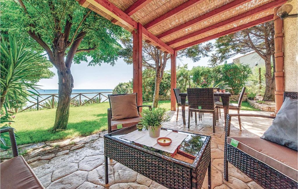 a patio with a gazebo with a table and chairs at Gorgeous Home In Menfi Ag With Wifi in Porto Palo
